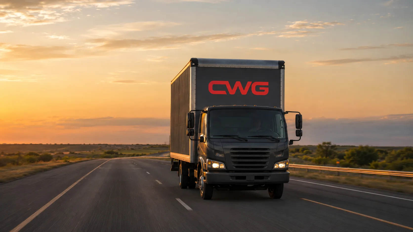 CWG box truck running an open Texas interstate at golden hour